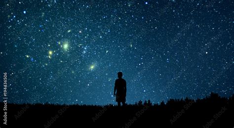 Man looking at the stars. Alone man looking at starry sky. Night sky. Stock Photo | Adobe Stock
