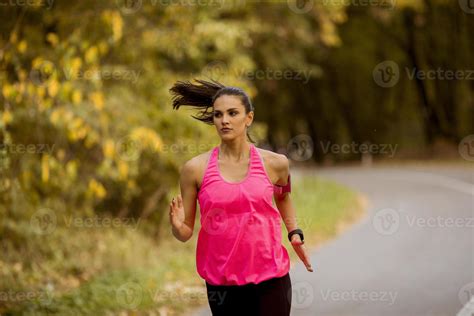 Young fitness woman running at forest trail 15706569 Stock Photo at Vecteezy