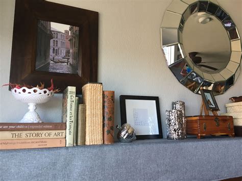 Two’s Company Ainsworth bevel frame round wall mirror. Gray linen table runner to elevate ...