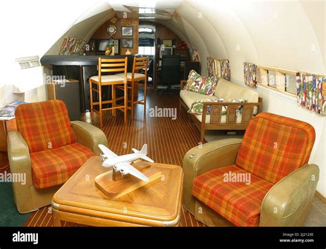 INTERIOR OF LIVING AREA WITH OWNER DAVE DRIMMER . THE PLANE BOAT IS A BOAT MADE FROM THE LAND ...