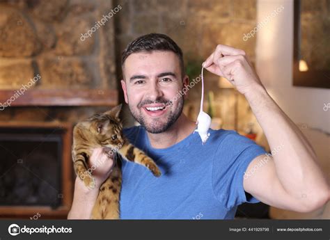 Portrait Handsome Young Man Holding Cat Toy Mouse Home Stock Photo by ©albejor2002@hotmail.com ...