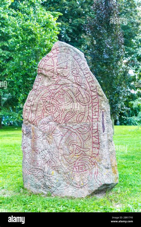 Stone with runic inscriptions that are in the university park, Uppsala, Sweden. Antique Runes on ...