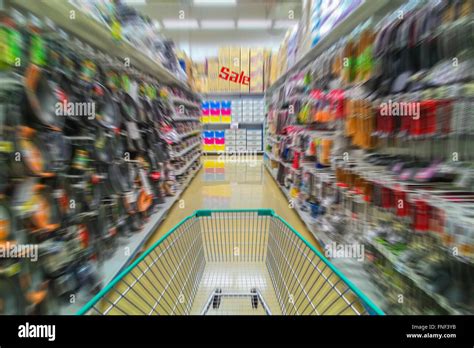 Running shopping cart in supermarket has sale wares in destinations ...