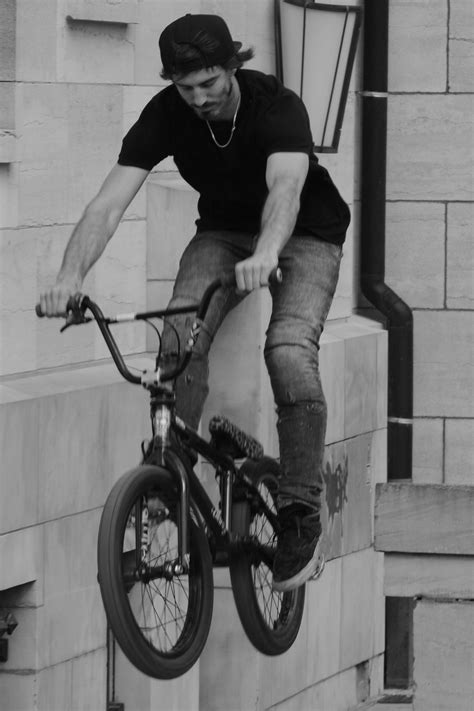 Black and white photo of a man, on the BMX bike, in jump free image download