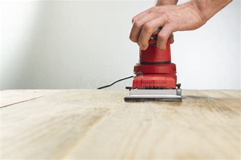 A Skilled Carpenter is Using the Power Sander As a Tool To Polish His ...