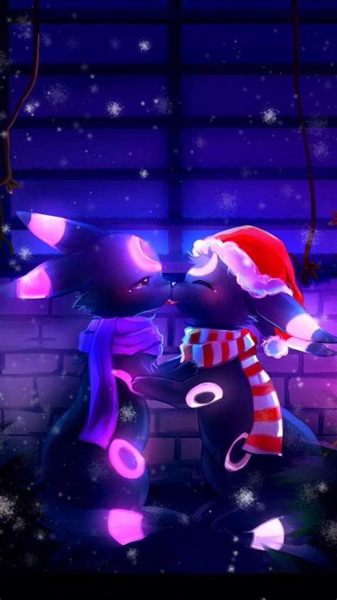 two black cats wearing christmas hats and scarves in front of a brick wall with snowflakes