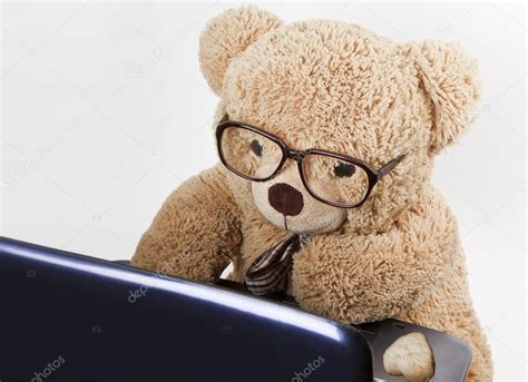 Teddy bear in glasses works behind a computer — Stock Photo © linavita ...