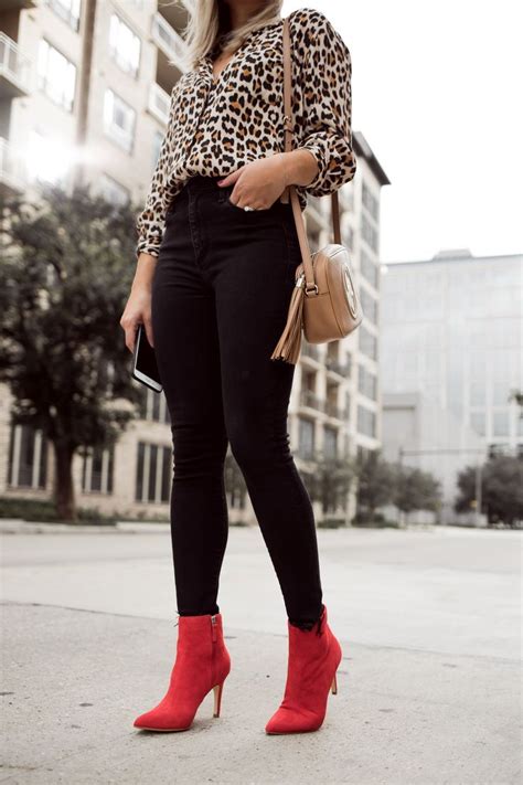 Houston fashion blogger Uptown with Elly Brown wears red ankle boots with a black skinny denim ...