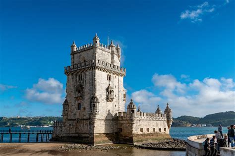 Belem Tower Near the River Under Blue Sky · Free Stock Photo