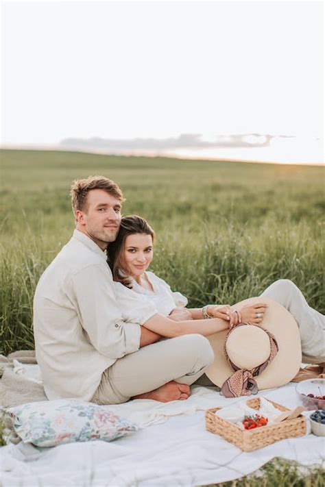 A Couple Having a Picnic on the Grass Field · Free Stock Photo