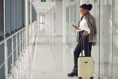 Free Photo | Black woman with suitcase at the airport