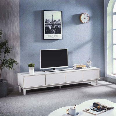 a living room with blue walls and a white entertainment center in front ...