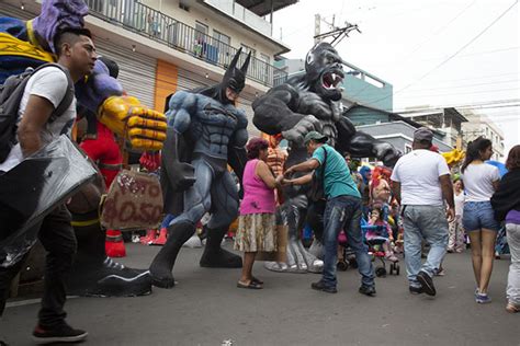 People walking past enormous paper-maché dolls | Año viejo effigy dolls | Guayaquil | Travel ...