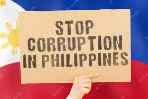 Premium Photo | The phrase stop corruption in philippines on a banner in men's hand with blurred ...