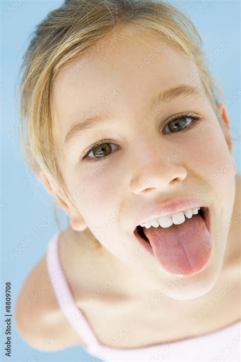 Young girl sticking her tongue out Stock Photo | Adobe Stock