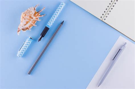 Premium Photo | Back to school School stationery and seashell on blue ...