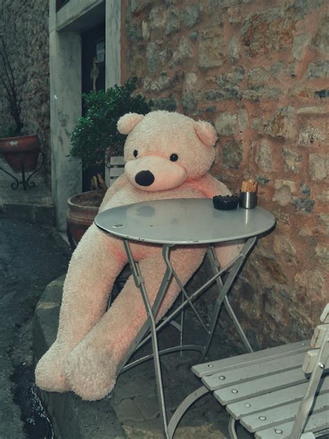 A Big Teddy Bear Sitting on a Chair Outside of a Building · Free Stock ...