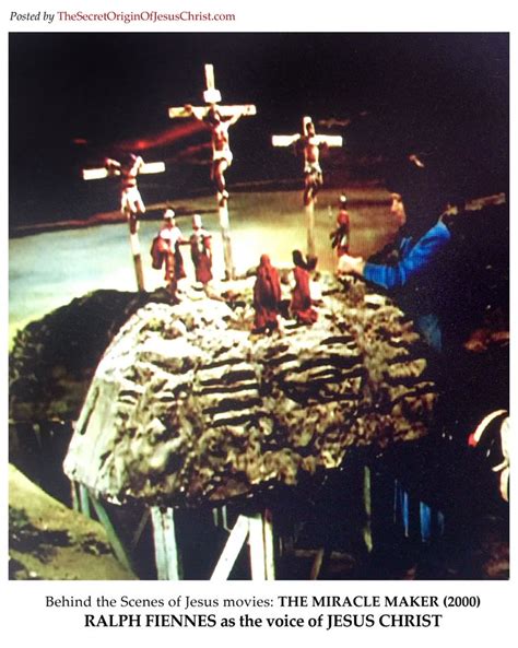 the crucifix is displayed on top of a rock with people standing around it