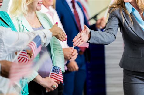 Female Politician Shaking Hands With Supporters At Event Stock Photo - Download Image Now - iStock