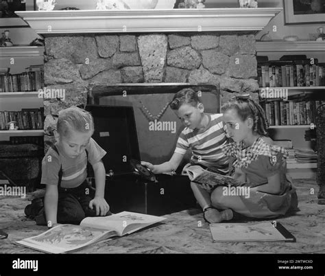 Three kids reading Black and White Stock Photos & Images - Alamy