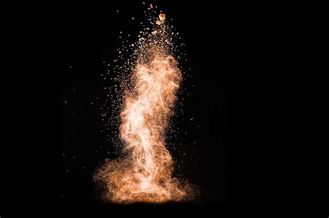 Premium Photo | Brown powder explosion on black background.