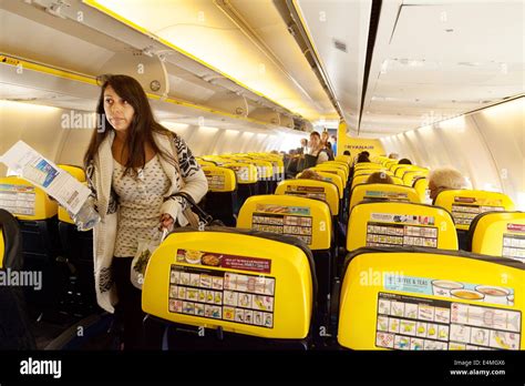 Passengers finding their seats, Ryanair plane cabin interior Stock Photo - Alamy