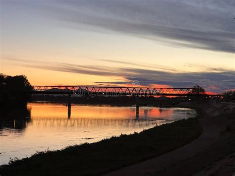 Silhouette of a Historic Bridge Over Water at Sunset in Slavonski Brod, Croatia Stock Photo ...