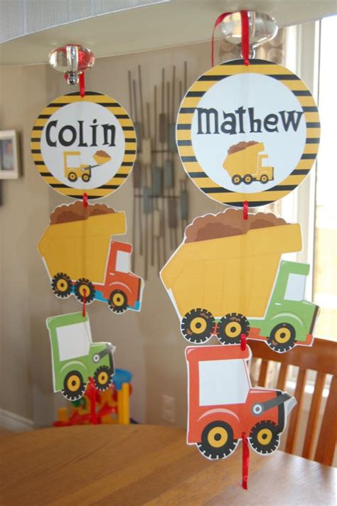 two construction vehicles hanging from the ceiling in front of a dining ...