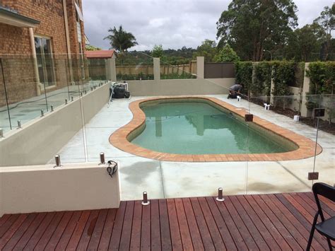 Custom raked glass pool fence panels. | Sydwest Fencing