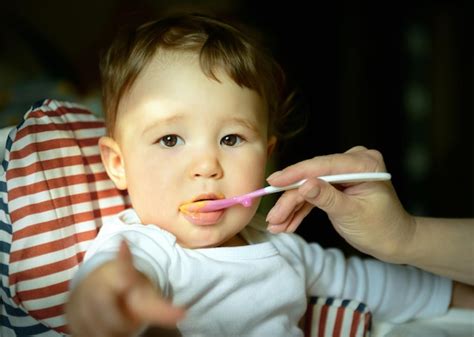 Premium Photo | The oneyearold child eats porridge