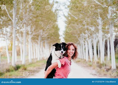 Young Woman Training Outdoors with Her Cute Border Collie Dog in a Trees Path Stock Image ...