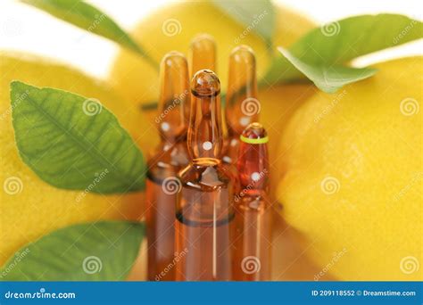 Vitamin C Injection.a Solution of Vitamin C in Brown Glass Ampoules Set, Lemons on a White ...
