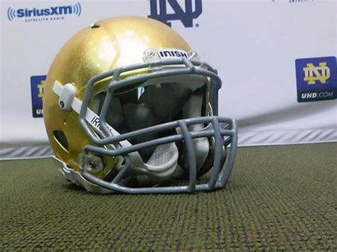 Notre Dame football team will don the new gold helmets