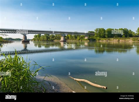 Po river at the medieval town of Piacenza, Italy. Car bridge that leads ...