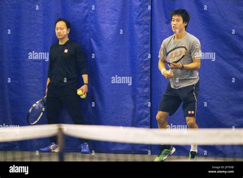 Kei Nishikori (R) of Japan practices with his coach Michael Chang on ...