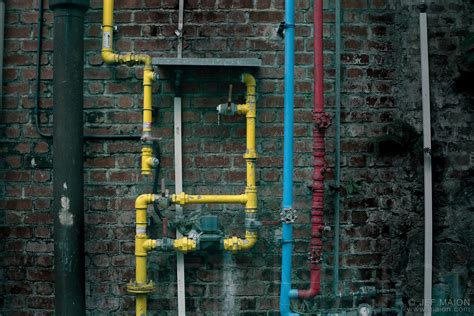 Image: Colorful pipes on brick wall | Stock photo by JF Maion