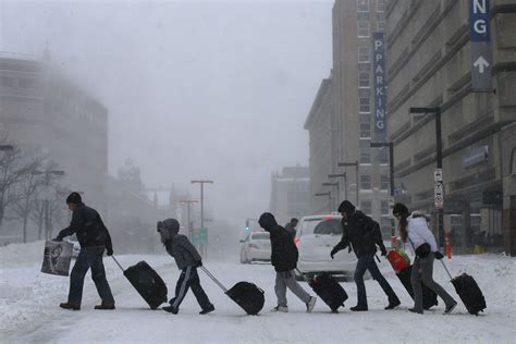 Travelers leave Back Bay train and subway station during winter nor ...