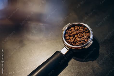 Portafilter holder full of coffee beans Stock Photo | Adobe Stock