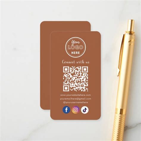 a business card with a qr code on it next to a pen and paper