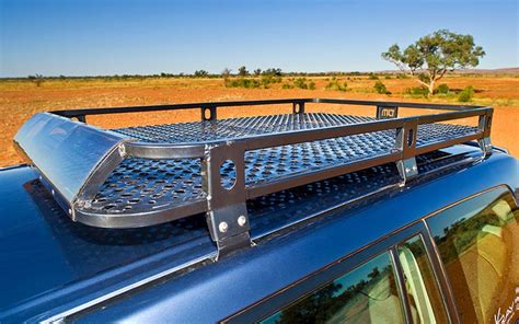 a truck with a metal roof rack in the desert