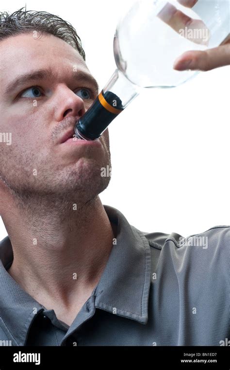 A man drinking from a wine bottle, isolated on white Stock Photo - Alamy