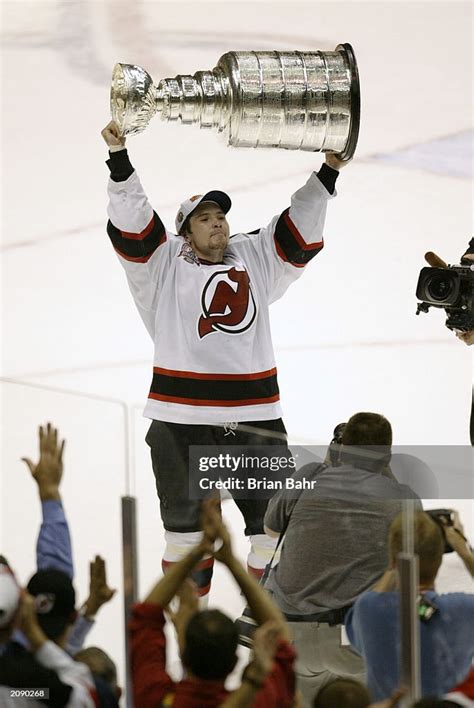 Sergei Brylin of the New Jersey Devils raises the Stanley Cup as he ...