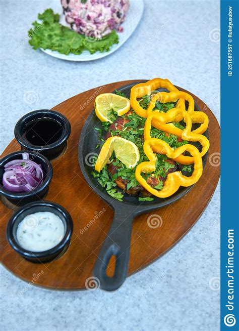 Deep Fried Whole Brisket in a Cast-iron Skillet with Sauces and Garnish Stock Image - Image of ...