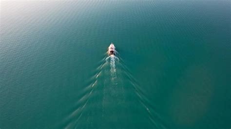 Premium Photo | The boat sails on lake balkhash at sunset