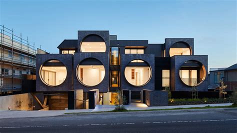 Oversized circular windows dominate the facade of Cirqua Apartments in ...