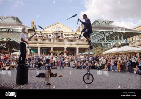 street performers juggling on unicycle in Covent Garden London Stock Photo: 8248800 - Alamy