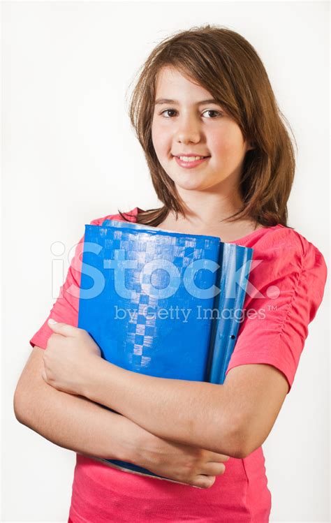 Portrait Of Smiling Teen Girl Holding Books Stock Photo | Royalty-Free ...