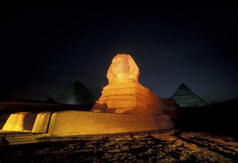 Pyramids And A Sphinx At Night In Giza Photograph by Richard Nowitz