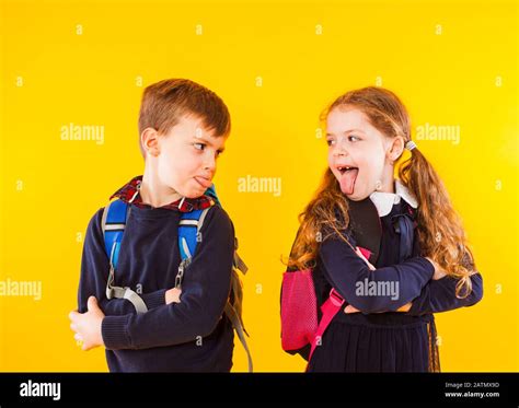 Funny kids in school uniform having fun together. Kids showing tongue each other Stock Photo - Alamy