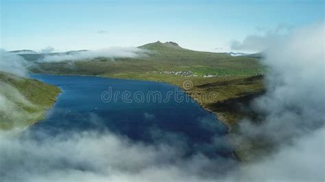 View of Sorvagsvatn Lake Above the Ocean and Legs Man Sitting Edge ...